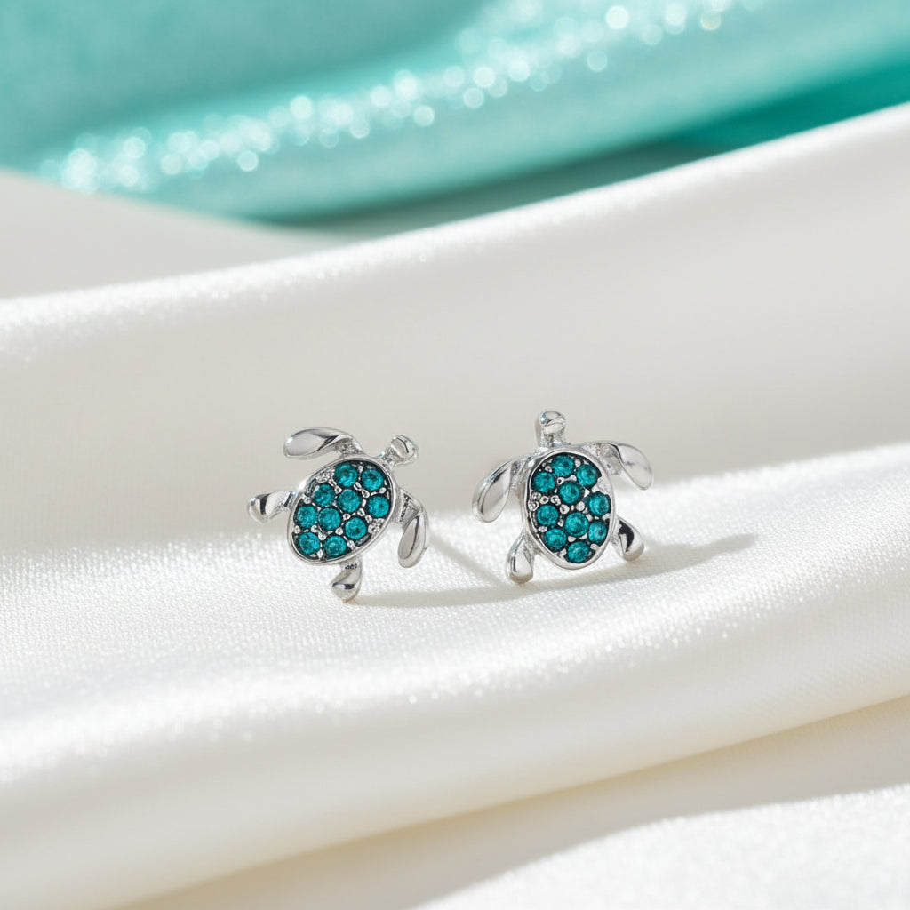 Aqua Pavé Sea Turtle Earrings on a white background