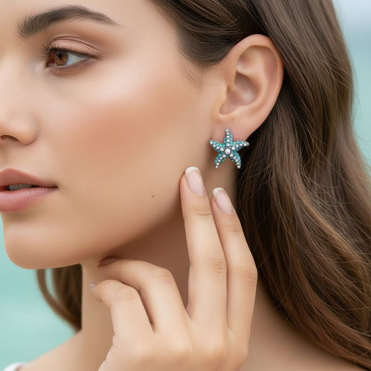 Ocean Pearl Pavé Starfish Earrings being worn and held up to the ear.