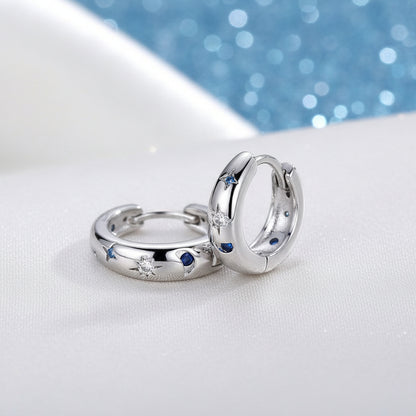 Celestial Star & Moon Hoop Earrings with embedded stones on a light background