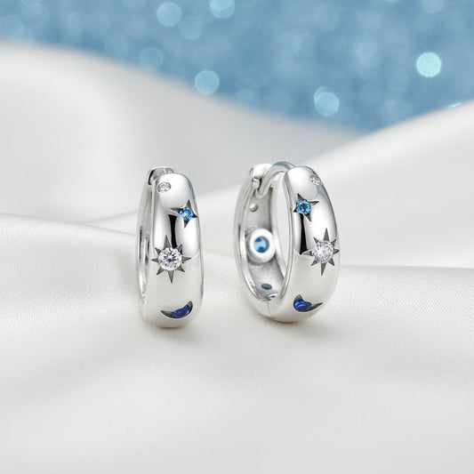 Celestial Star & Moon Hoop Earrings with star and blue gemstone designs on a white background