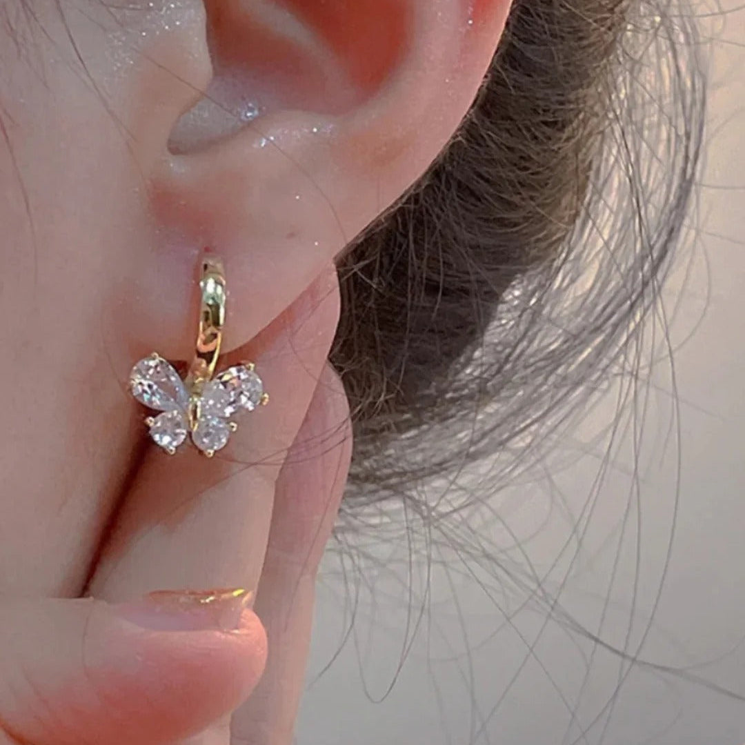 Woman wearing Gold Crystal Butterfly Hoop Earrings