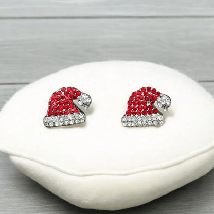 Santa Hat Rhinestone Earrings with clear stones on a white cushion