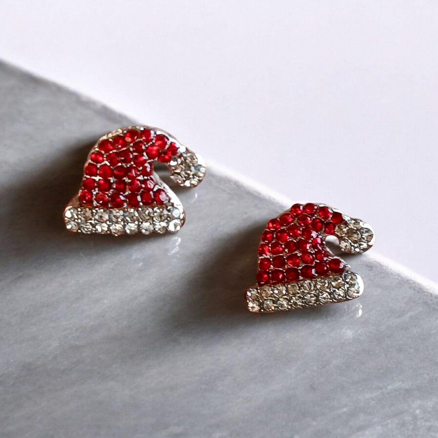 Santa Hat Rhinestone Earrings on a light gray surface