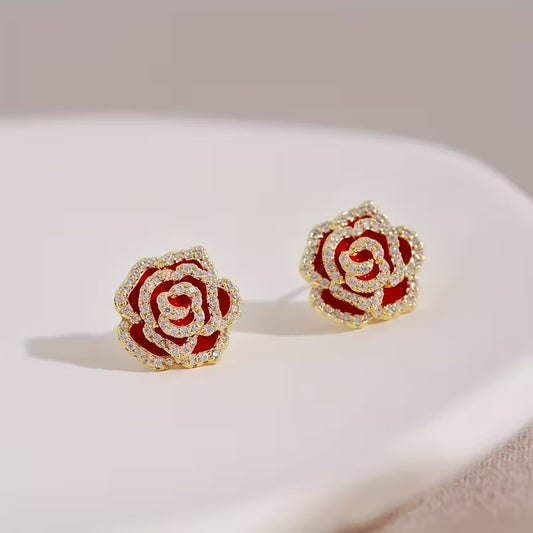 Rhinestone Rose Earrings with gold accents on a light surface