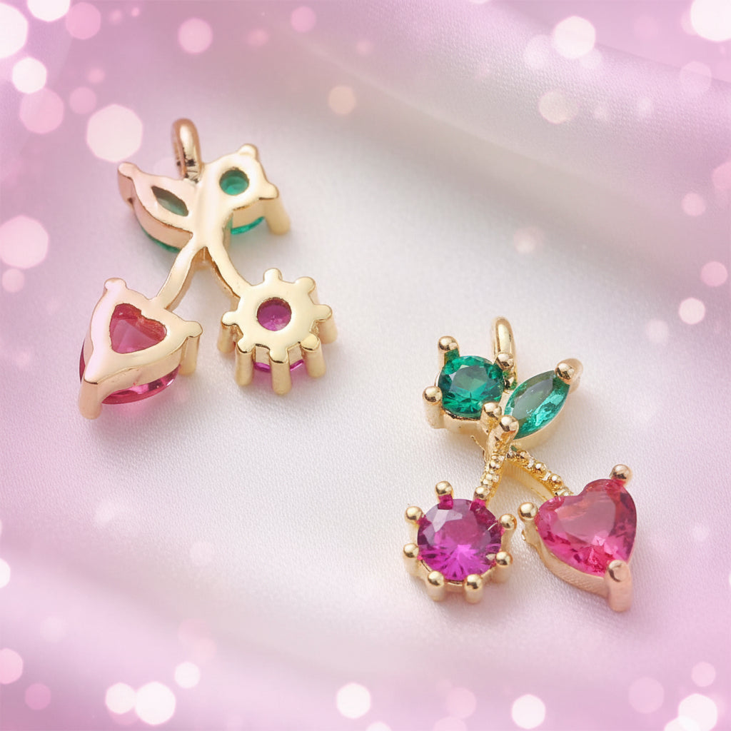 Petite Pink Cherry Heart Earrings with heart and gemstone details on a pink background