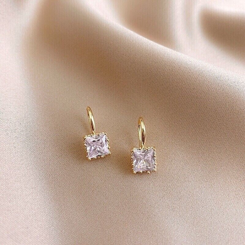 Classic Square Zircon Drop Earrings on a beige fabric background