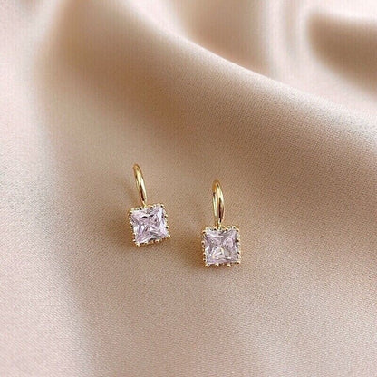 Classic Square Zircon Drop Earrings on a beige fabric background