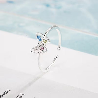 Pastel Butterfly Adjustable Ring on a light blue and white background