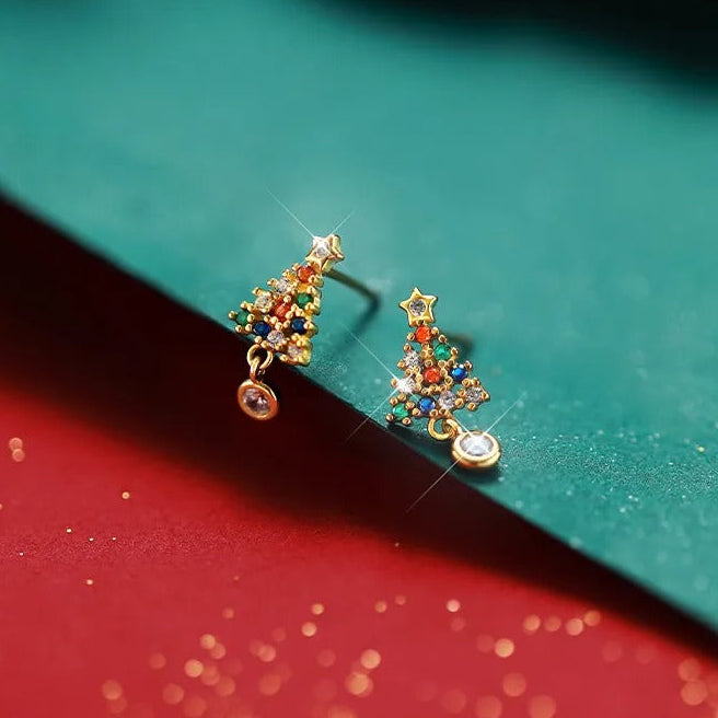 Twinkling Christmas Tree Earrings on a green and red background