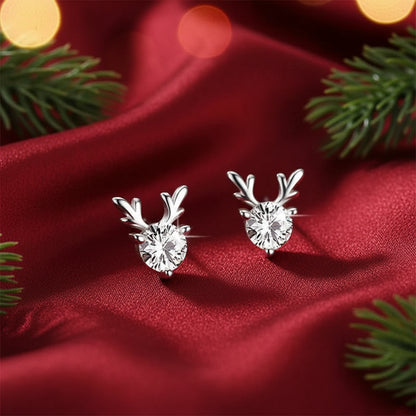 Crystal Silver Reindeer Earrings with a clear gemstone on a glittery surface