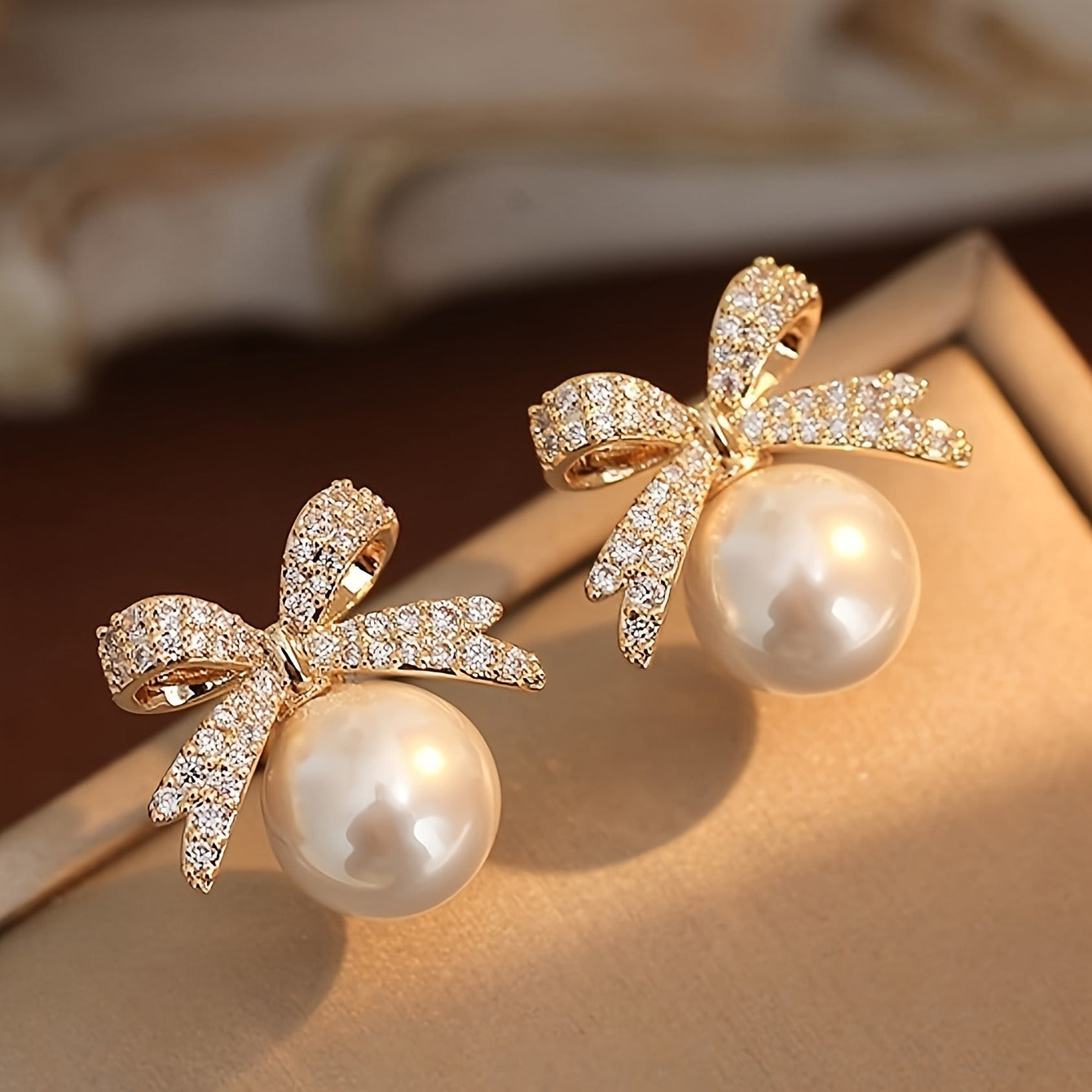 White Ornament Bow Earrings on a soft surface