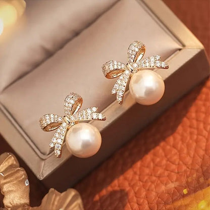 White Ornament Bow Earrings on a jewelry box