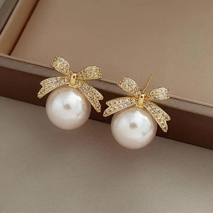 White Ornament Bow Earrings on a neutral background