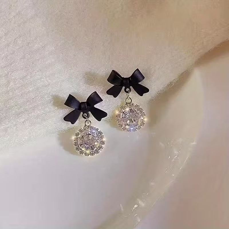 Pair of Black Bow Crystal Drop Earrings on a white background