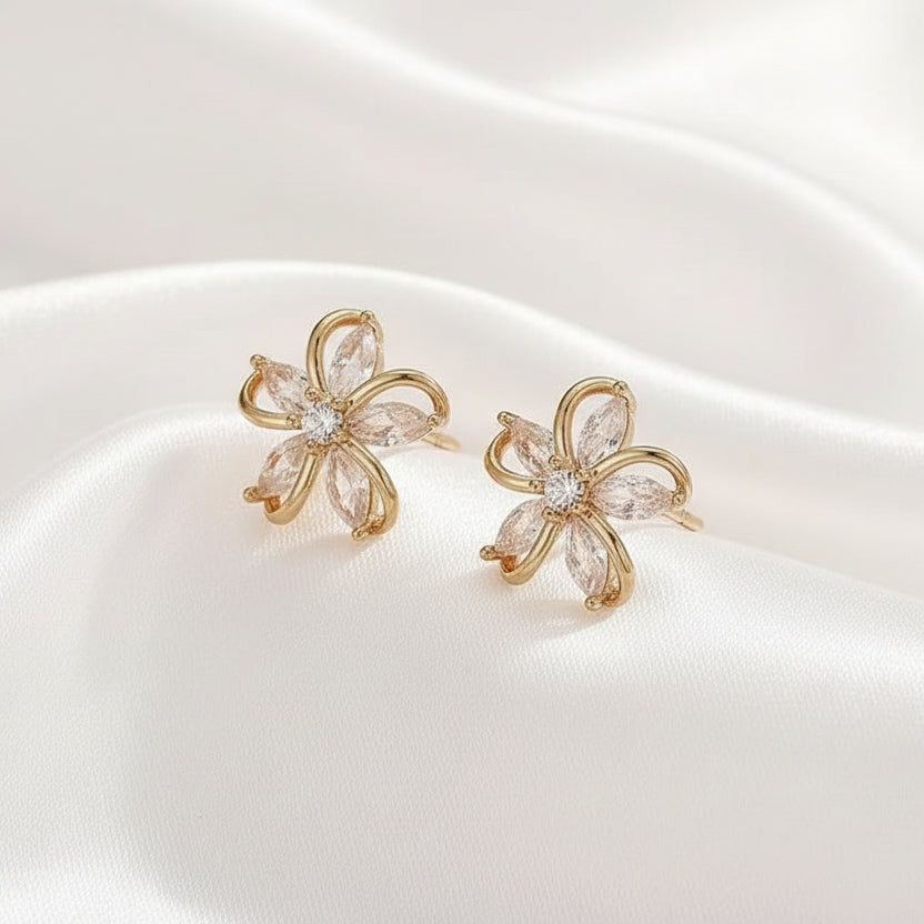 Gold Crystal Flower Earrings with clear stones on a white background