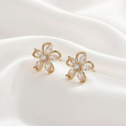 Gold Crystal Flower Earrings with clear stones on a white background