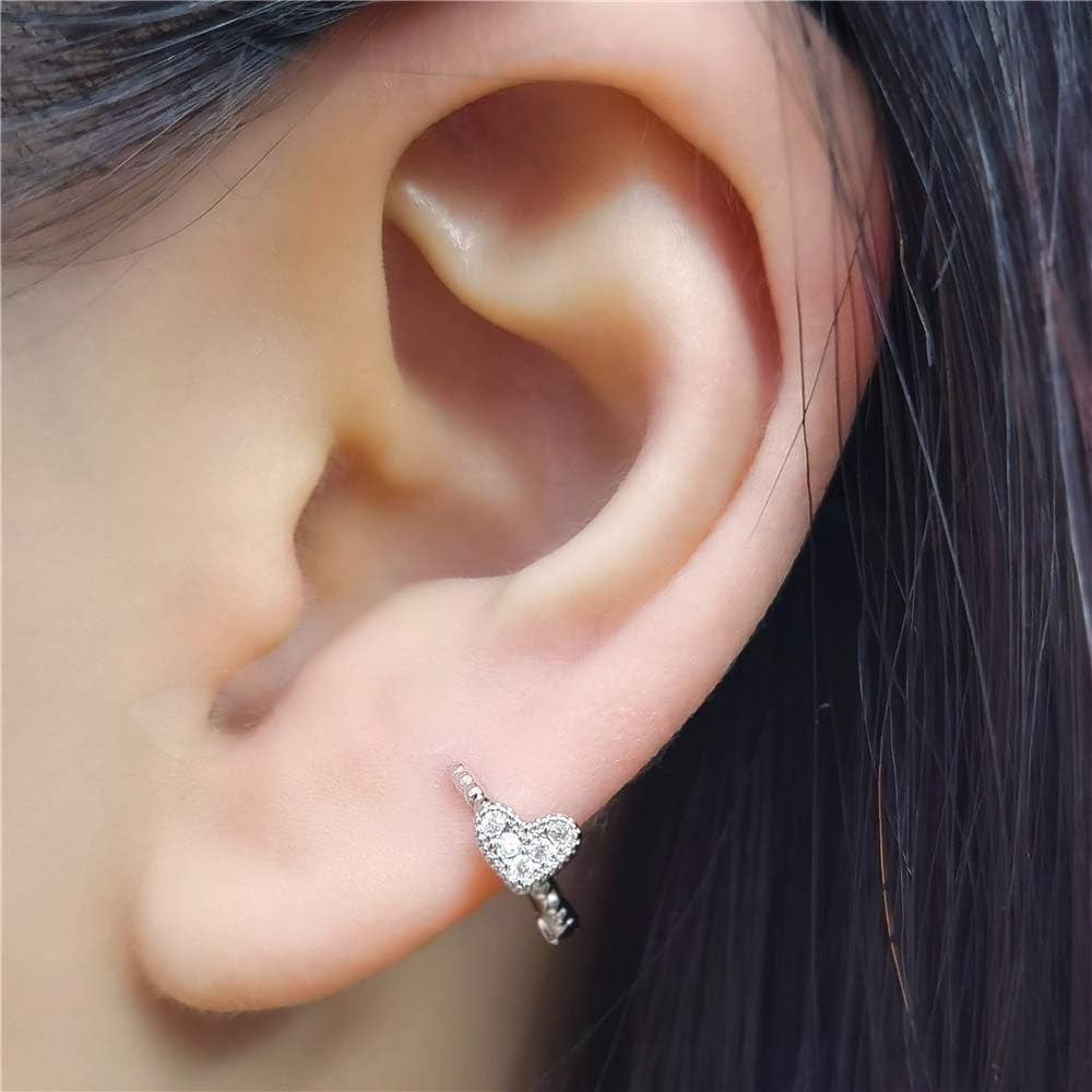 Close-up of an ear with a Silver Tiny Crystal Heart Earrings