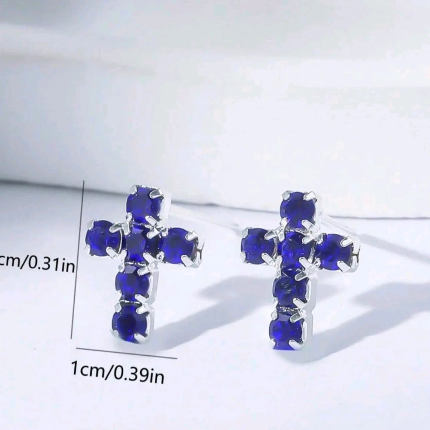 Silver Mini Blue Crystal Cross Earrings with blue gemstones on a white background and dimensions