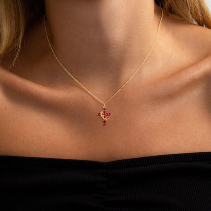 Pink & Gold Cross Crown Faith Necklace on a person wearing a black top.