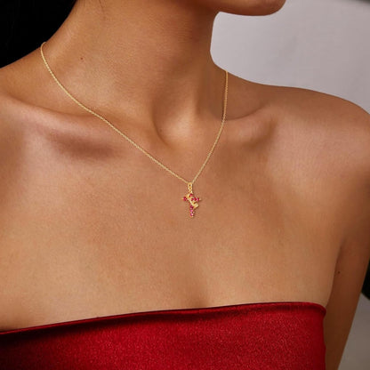 Pink & Gold Cross Crown Faith Necklace worn by a person in a red top.
