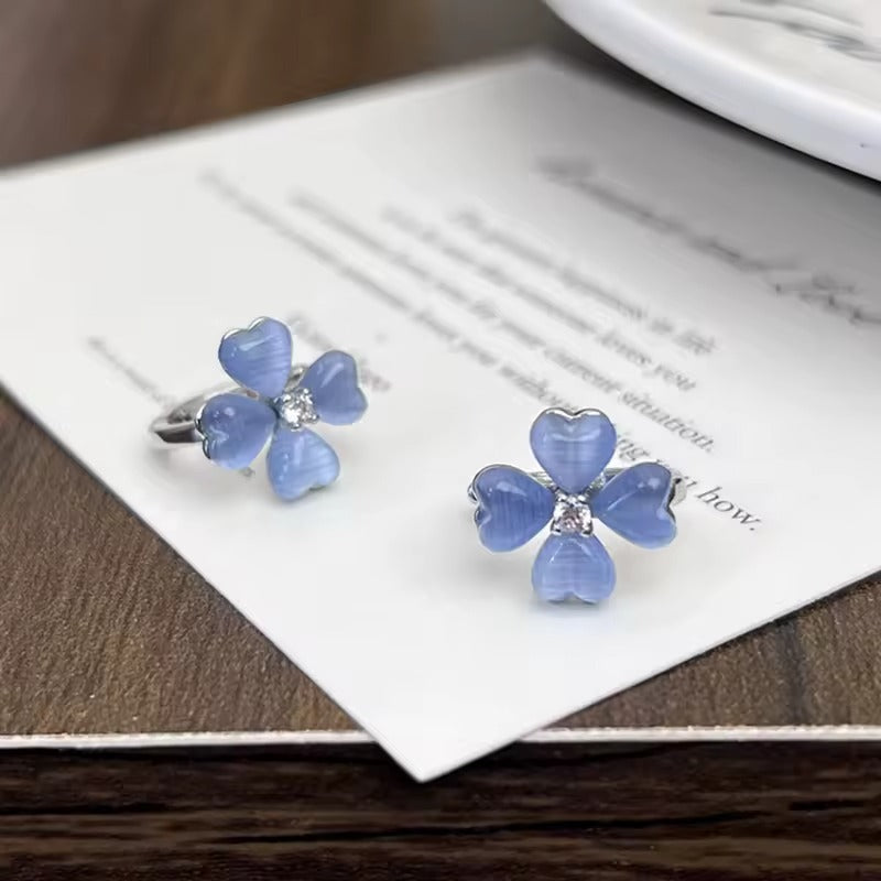 Blue Flower Petal Hoop Earrings on a card with blurred background