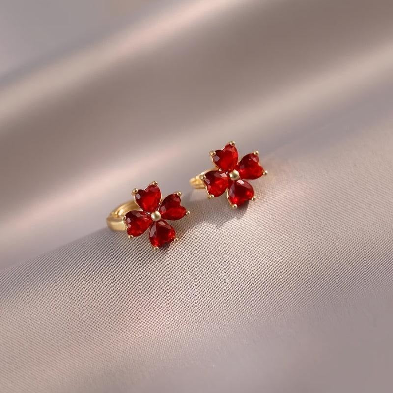 Ruby Red Flower Petal Hoop Earrings on a beige fabric background
