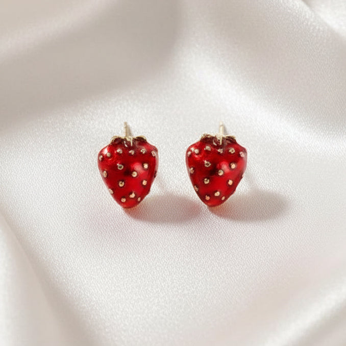 Ruby Red Strawberry Earrings on a white fabric background