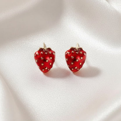 Ruby Red Strawberry Earrings on a white fabric background