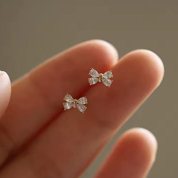Person holding Mini Crystal Bow Earrings