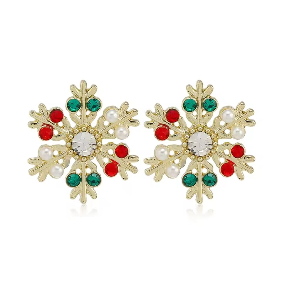 Gold Gemstone Snowflake Earrings with red, green, and pearl accents on a white background
