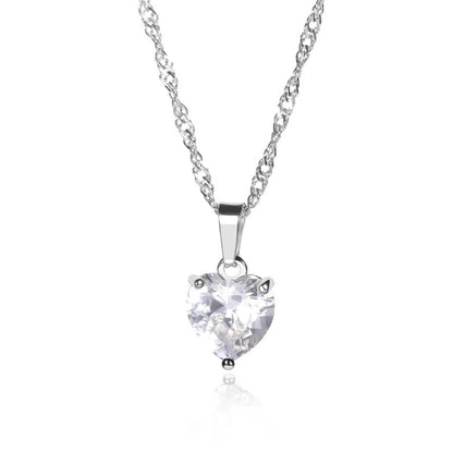Heart-shaped diamond pendant on a chain against a white background
