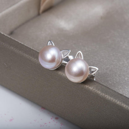 Pearl Cat Earrings on a gray surface