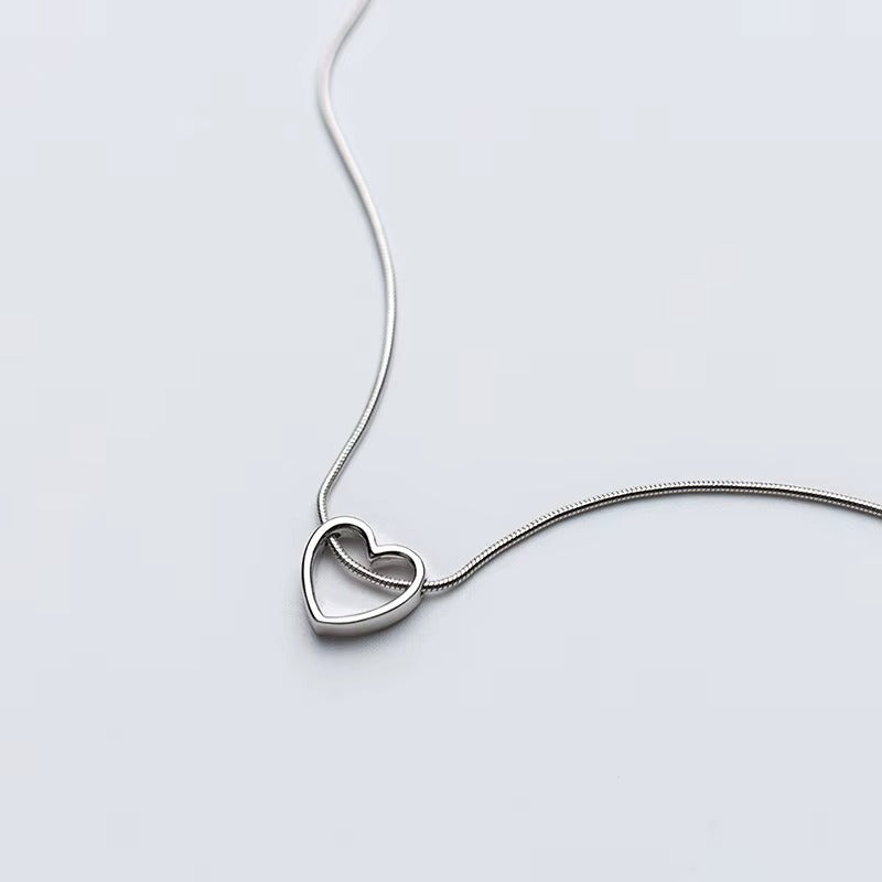 Sterling Silver Open Heart Necklace on a light gray background