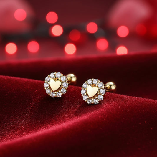 Tiny Gold Heart Halo Earrings with clear stones on a white surface