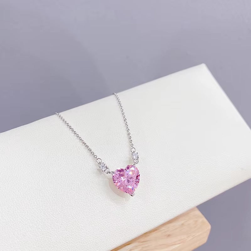Pink Zirconia Heart Necklace on a white stand with a gray background