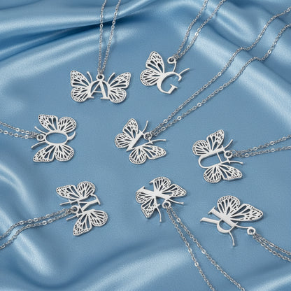 Silver butterfly necklaces on a blue background