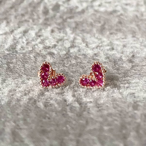 Petite Pink Zircon Heart Earrings on a textured gray background