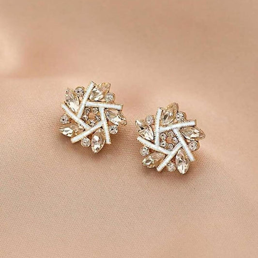 Golden Crystal Snowburst Earrings on a beige background