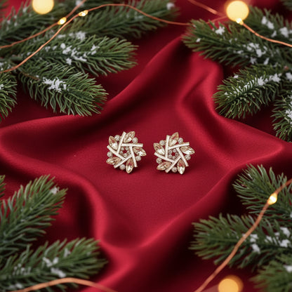 Golden Crystal Snowburst Earrings on a beige background