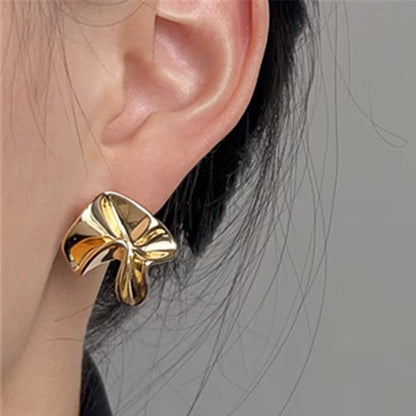 Gold Sculpted Petal Earrings worn by a person with a neutral background