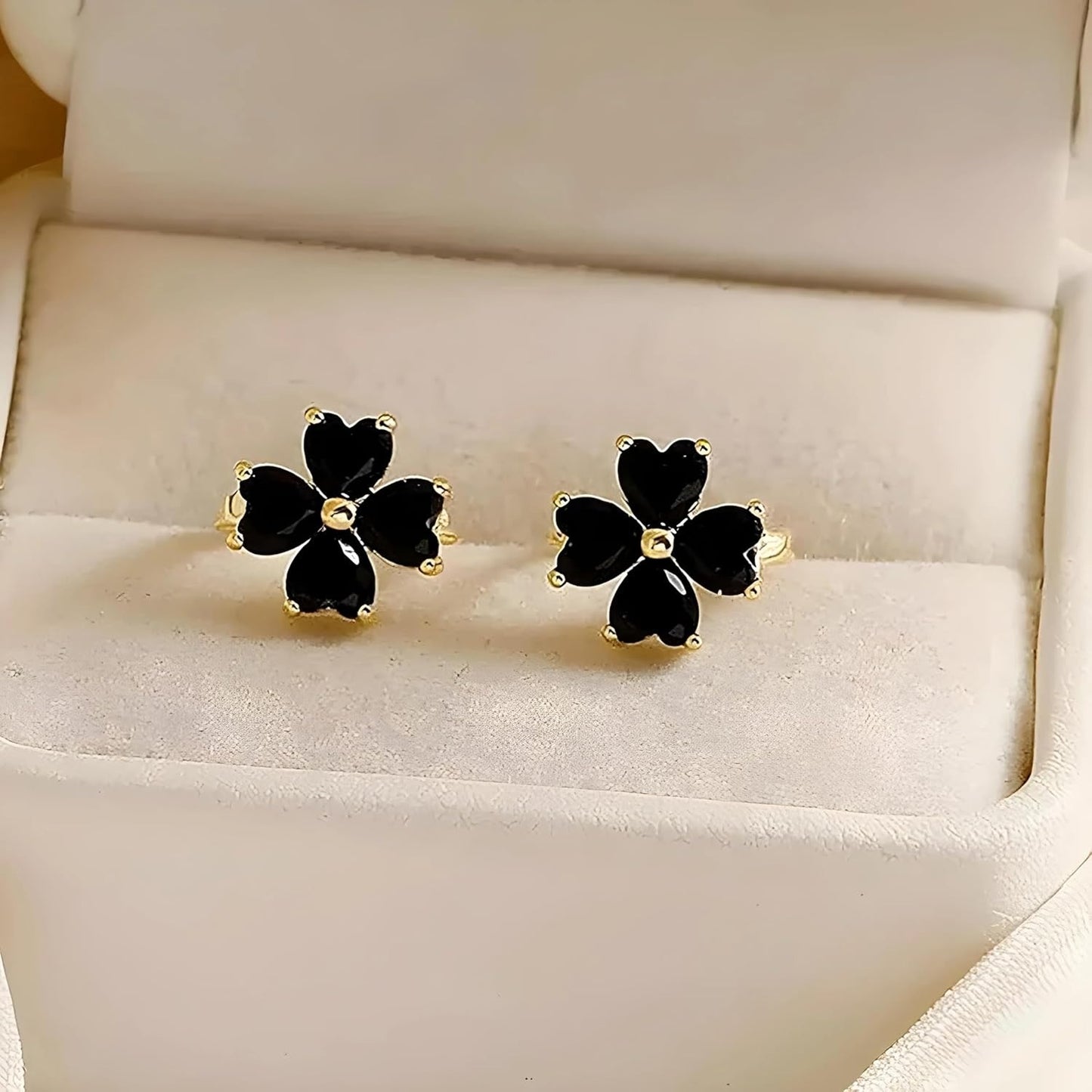 Black Flower Petal Hoop Earrings on a white jewelry display box