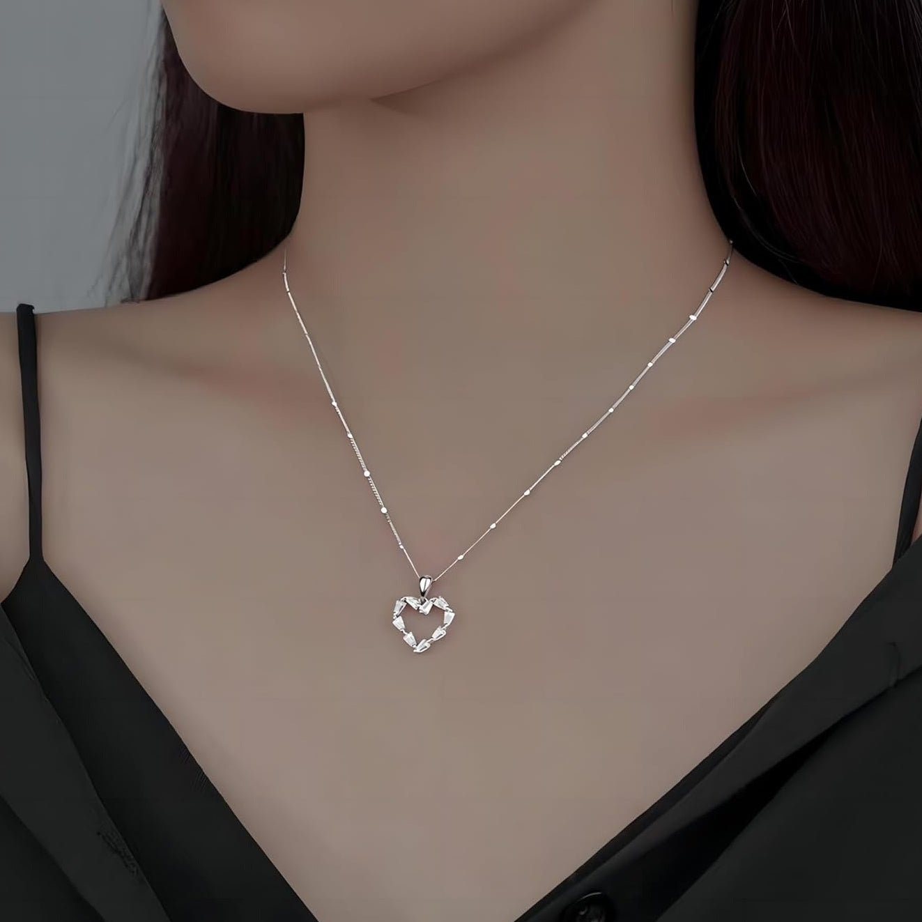 Silver Crystal Heart Necklace on a model wearing a black top.