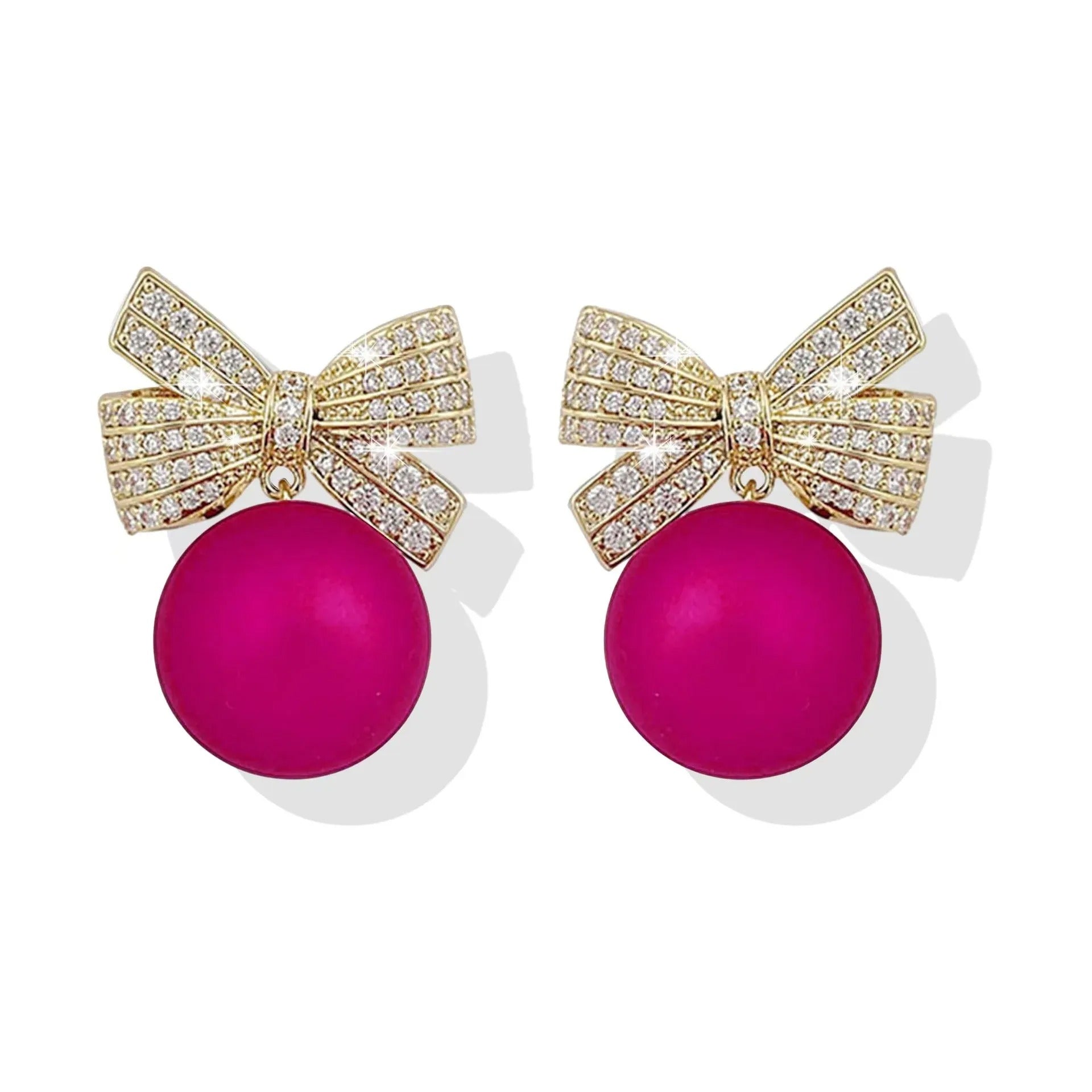 Pink ornament bow earrings on a white background
