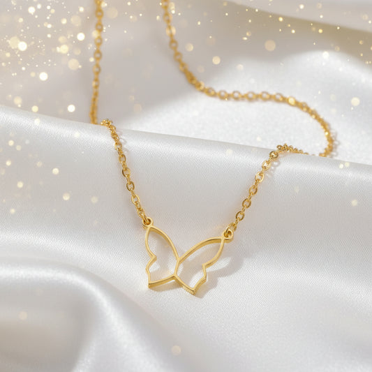 Butterfly Gold Necklace on a white fabric background