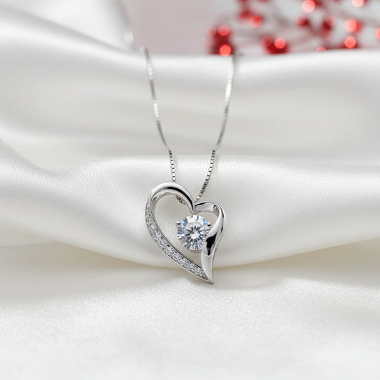 Forever Heart CZ Necklace with a diamond pendant on a white fabric background