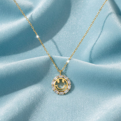 Gold Crystal Smiley Face Necklace on a light blue background