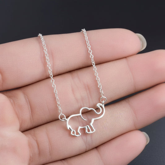 Silver Lucky Elephant Necklace on a hand against a dark background