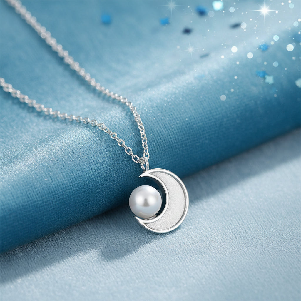 Silver Crescent Moon Pearl Necklace with a crescent moon and pearl pendant on a white background